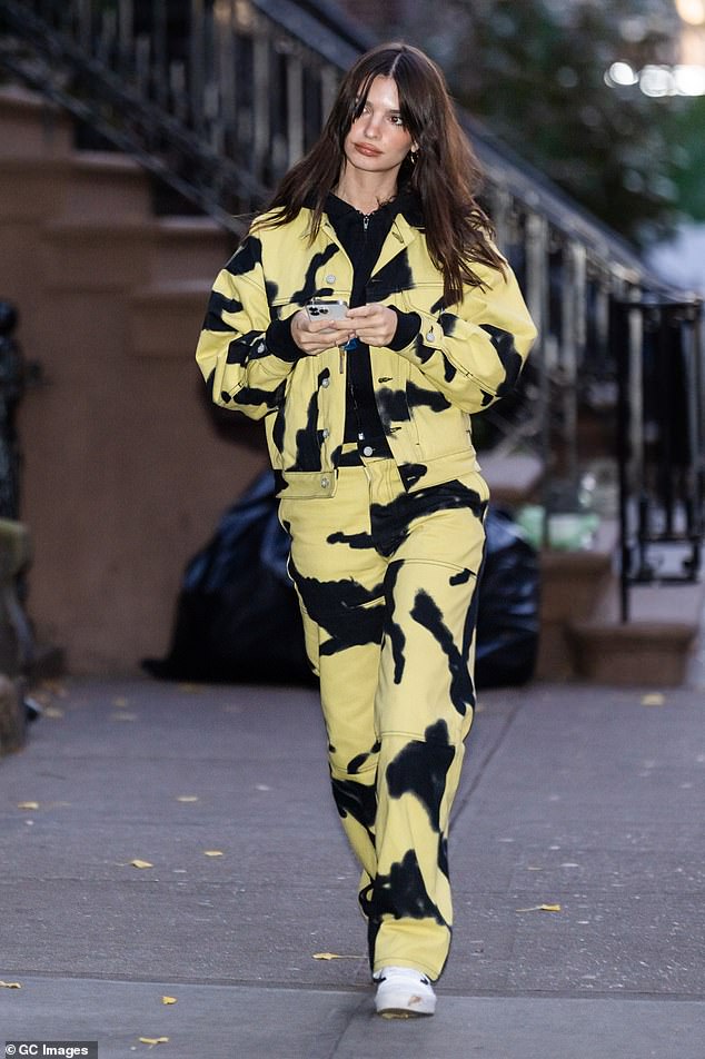 Unique: The model/actress, 31, strolled the sidewalk in a cropped yellow and black cow-print jacket worn with matching baggy pants