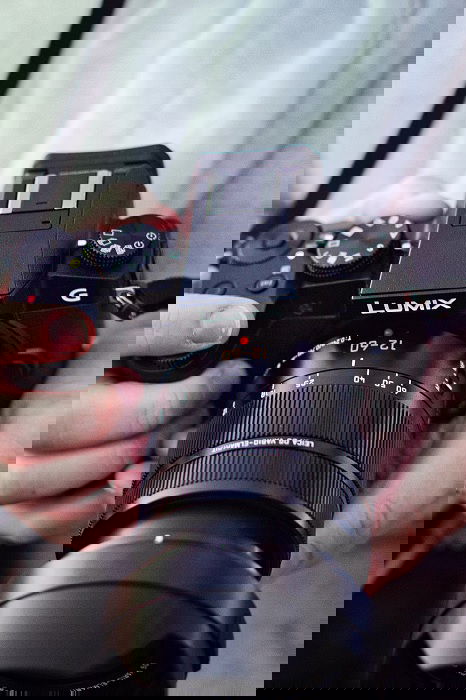 Close-up of hands holding a Panasonic Camera