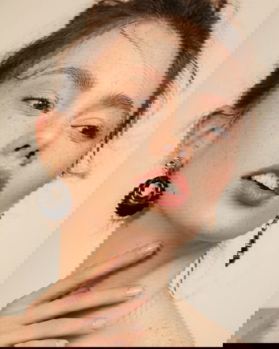 portrait of a woman touching her neck with her fingers