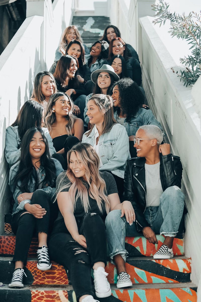 Group of young women sitting on stairs