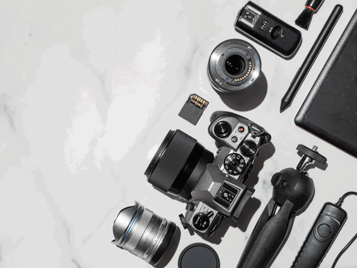 A knolling shot of camera surrounded by camera accessories A knolling shot of camera surrounded by camera accessories